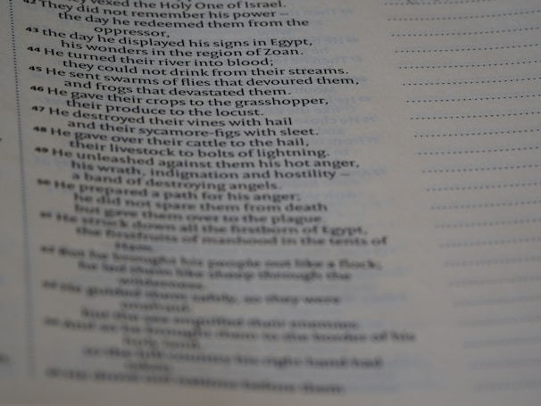 The image features a close-up view of a page from a religious text, possibly a Bible, displaying a number of verses arranged in a column. The text appears to be discussing historical events and divine actions.