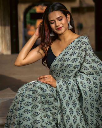 a woman wearing a green and black sari