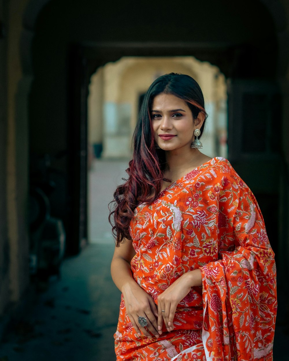 a woman in an orange and white sari