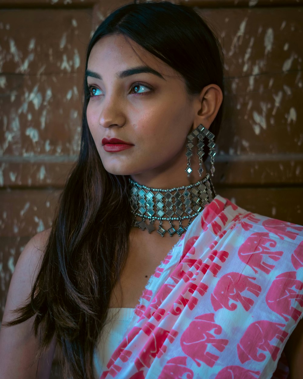 a woman wearing a pink and white sari