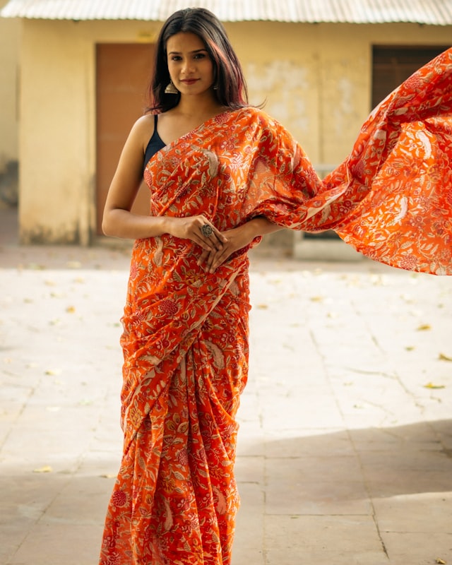 Saffron orange silk Patola saree with intricate printed pattern