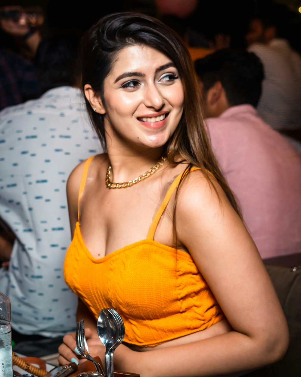 a woman in a yellow dress sitting at a table