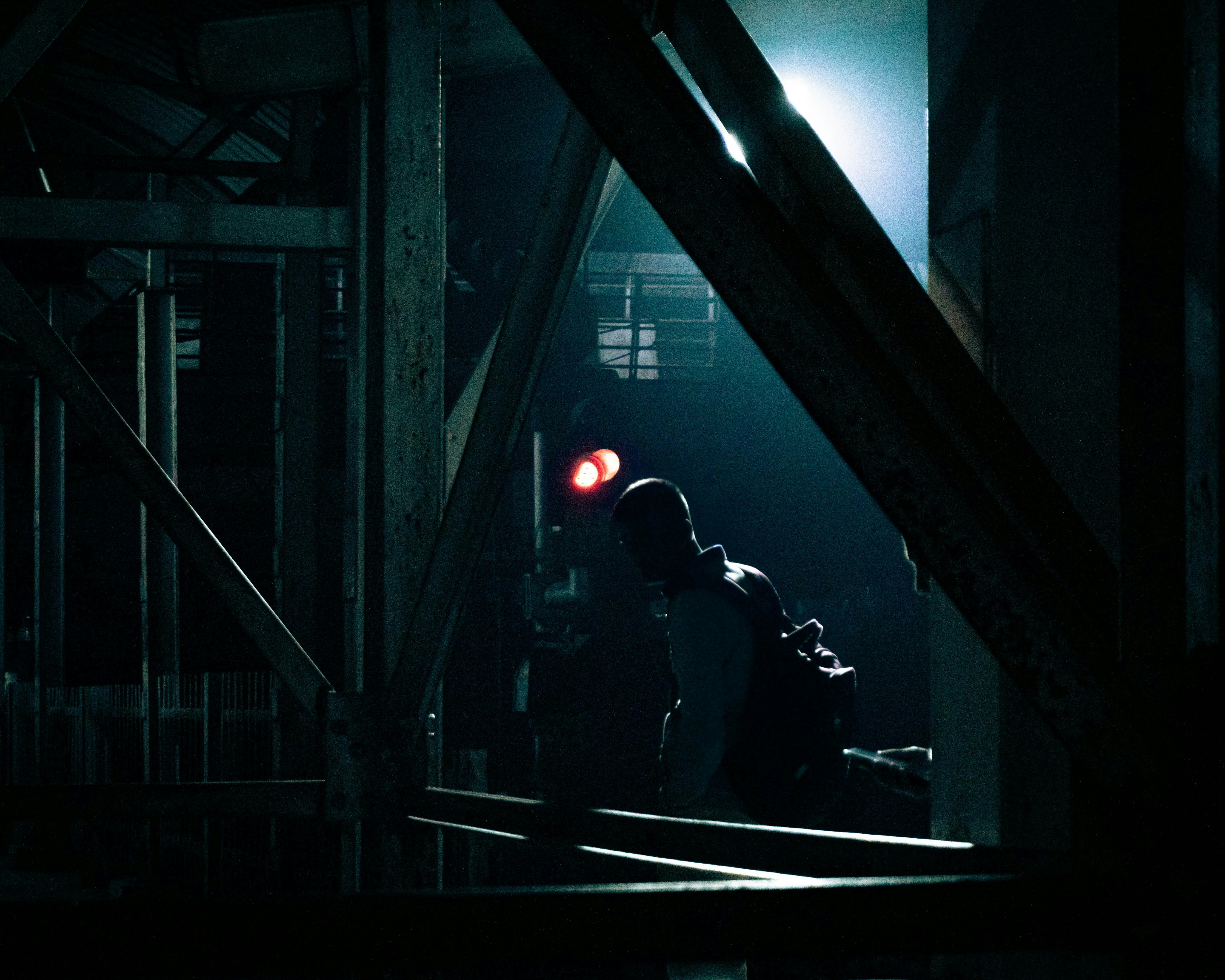 a person standing in a dark room with a red light