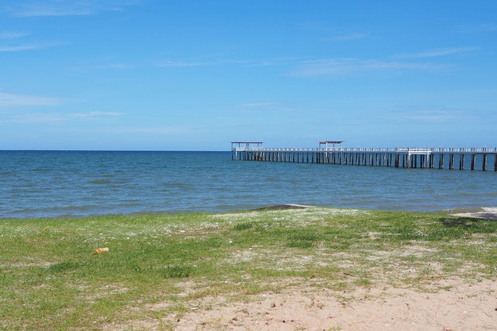 a long pier stretches out into the ocean