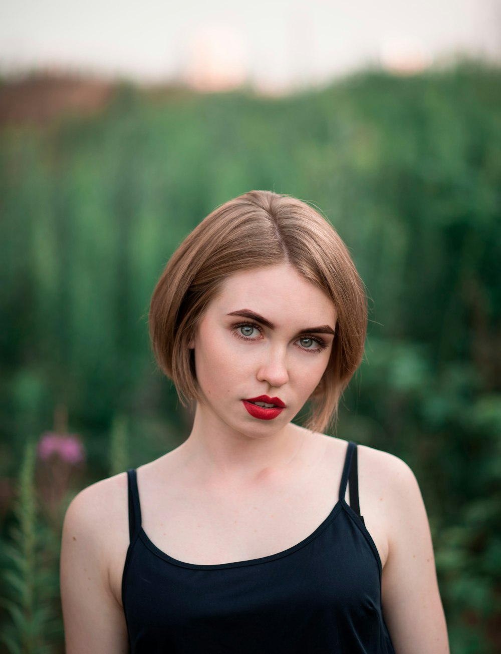 a woman with red lipstick and a black top