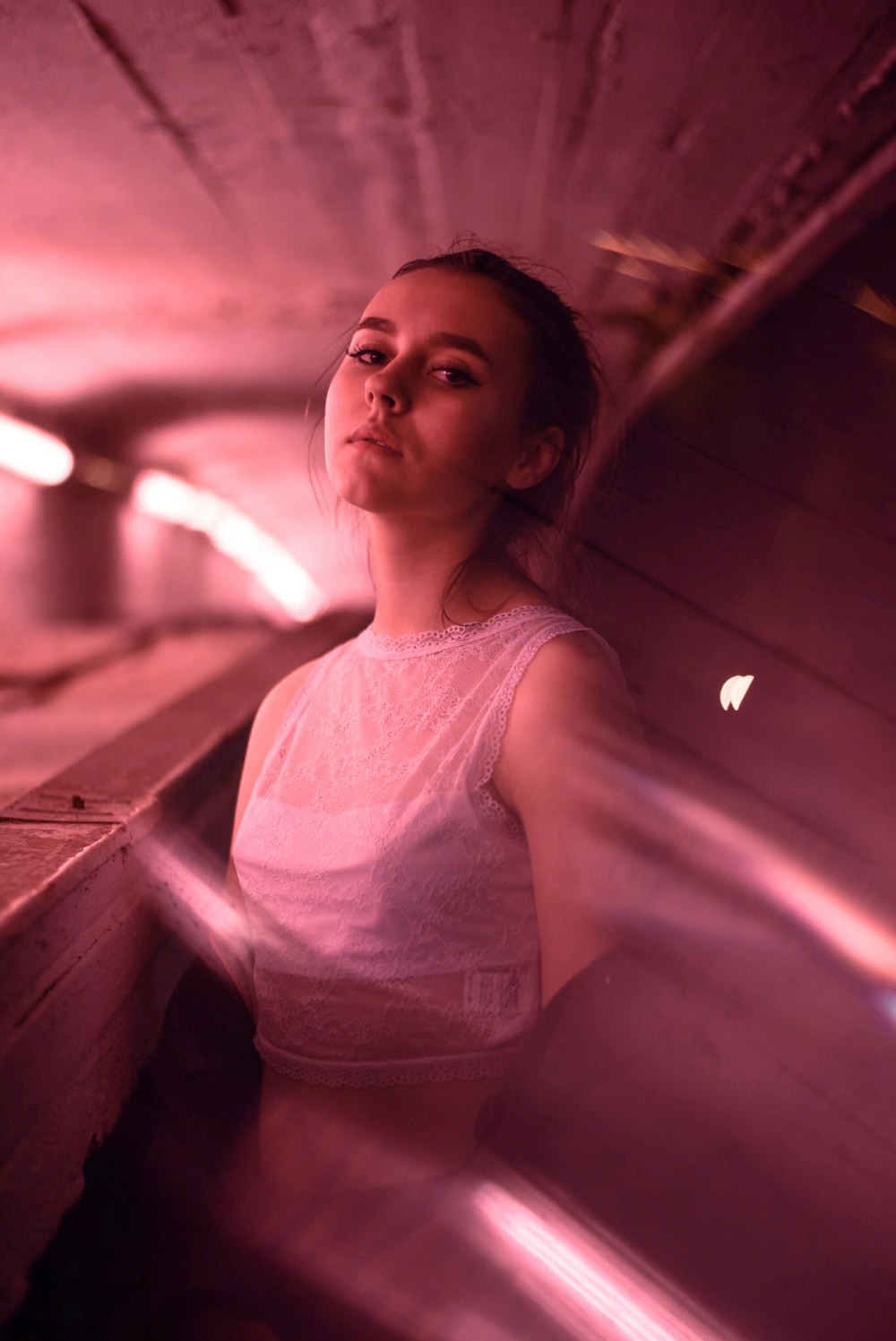 a woman standing in a tunnel with her eyes closed