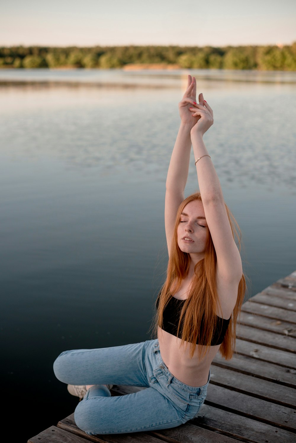 a woman standing in front of a body of water