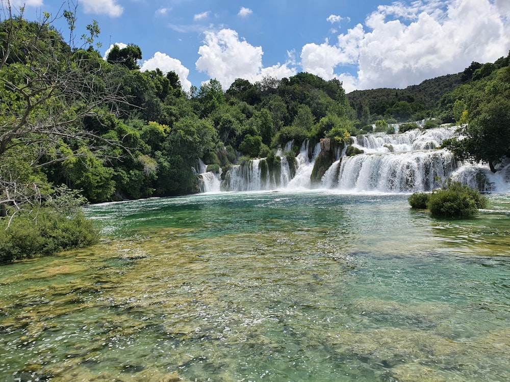 a river with a waterfall in the background