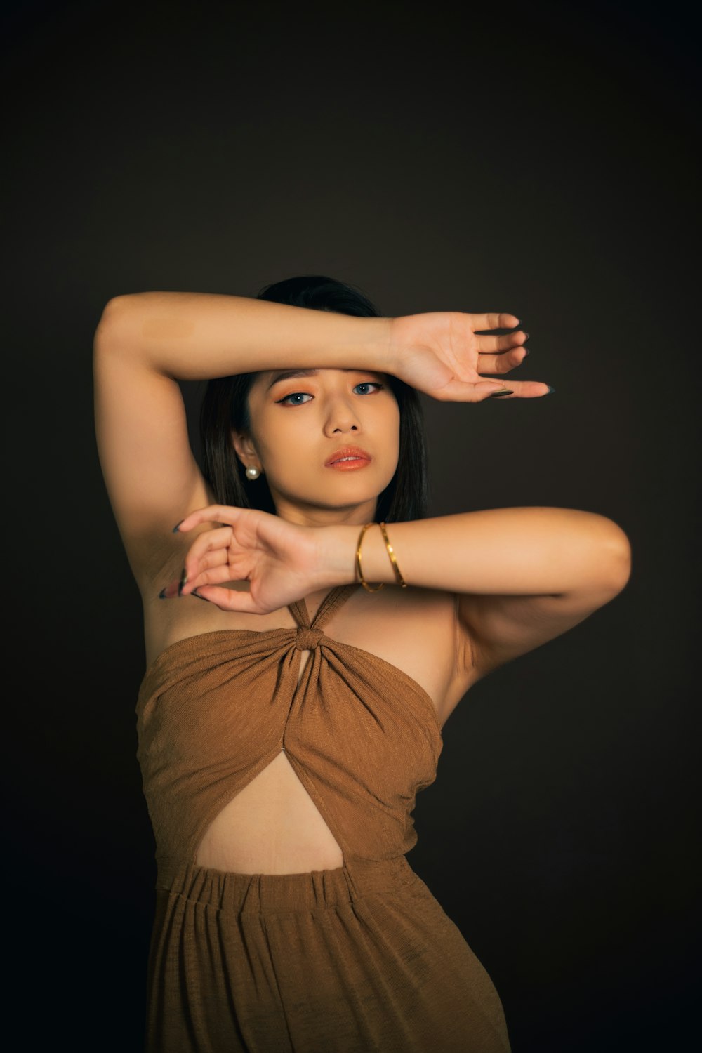 a woman in a brown dress posing for a picture