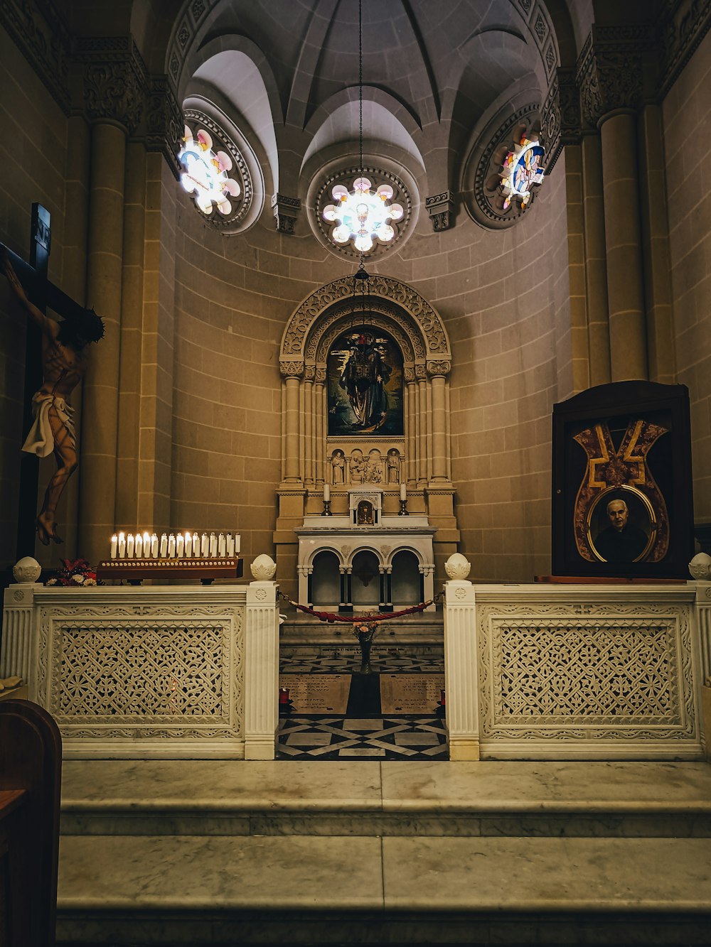 a church with a stone alter and stained glass windows