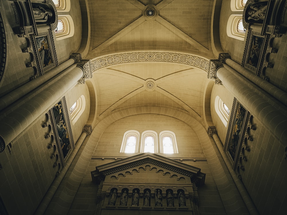 the ceiling of a large building with a clock on it