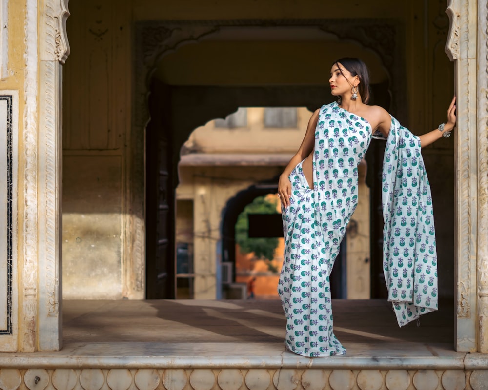 a woman in a white and blue sari