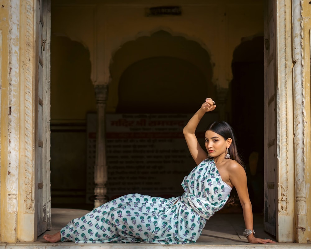 a woman in a blue and white dress posing for a picture