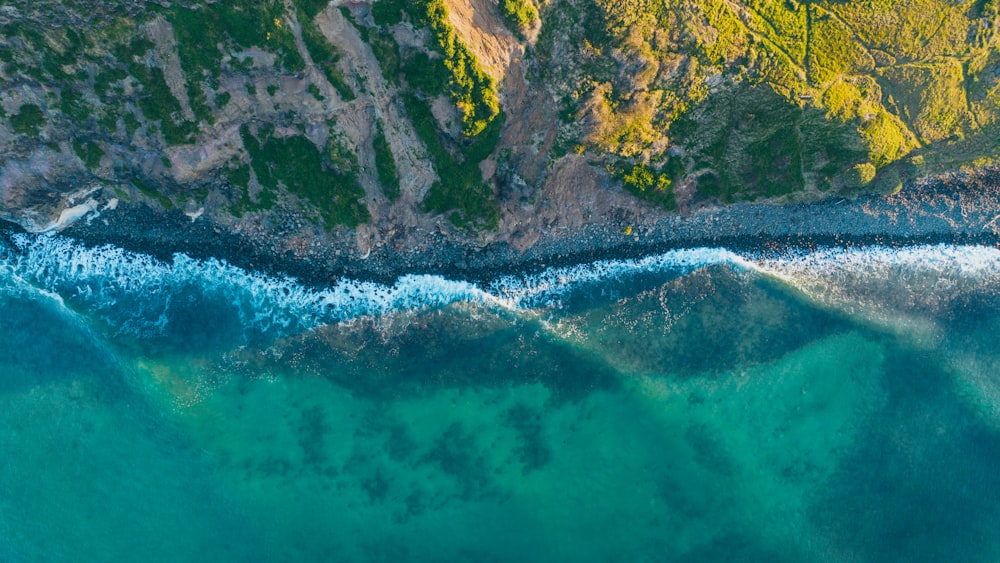 an aerial view of the ocean and mountains