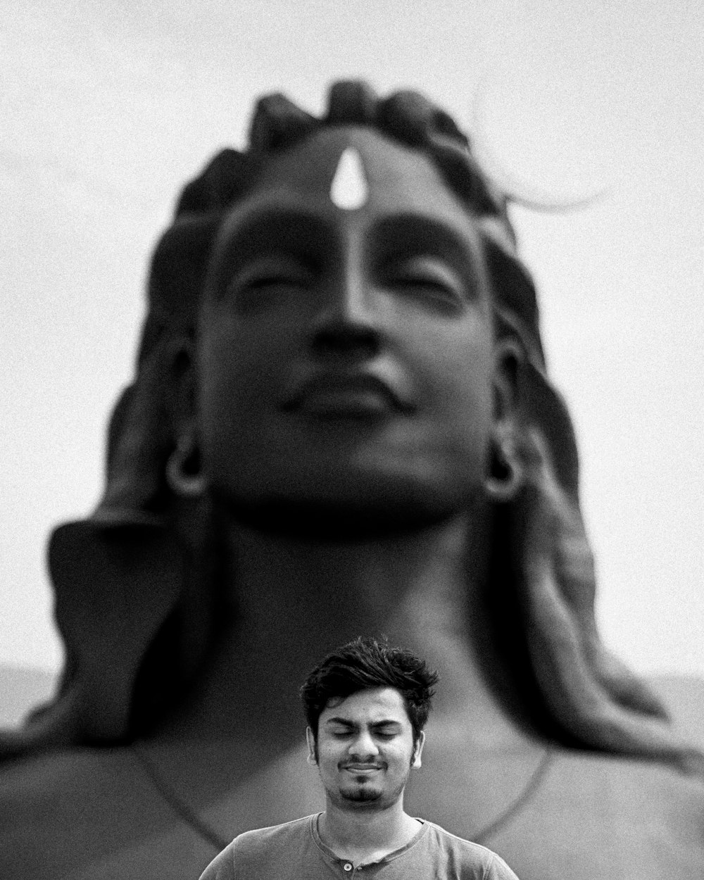 a man standing in front of a statue