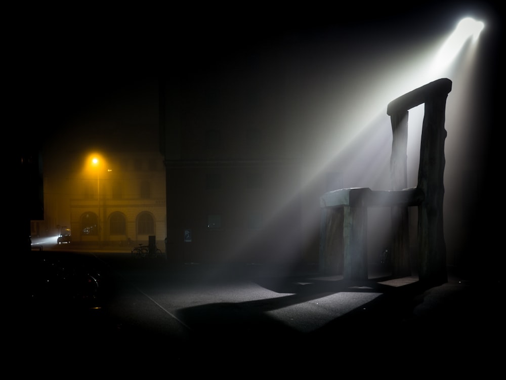 a light shines through the fog on a building