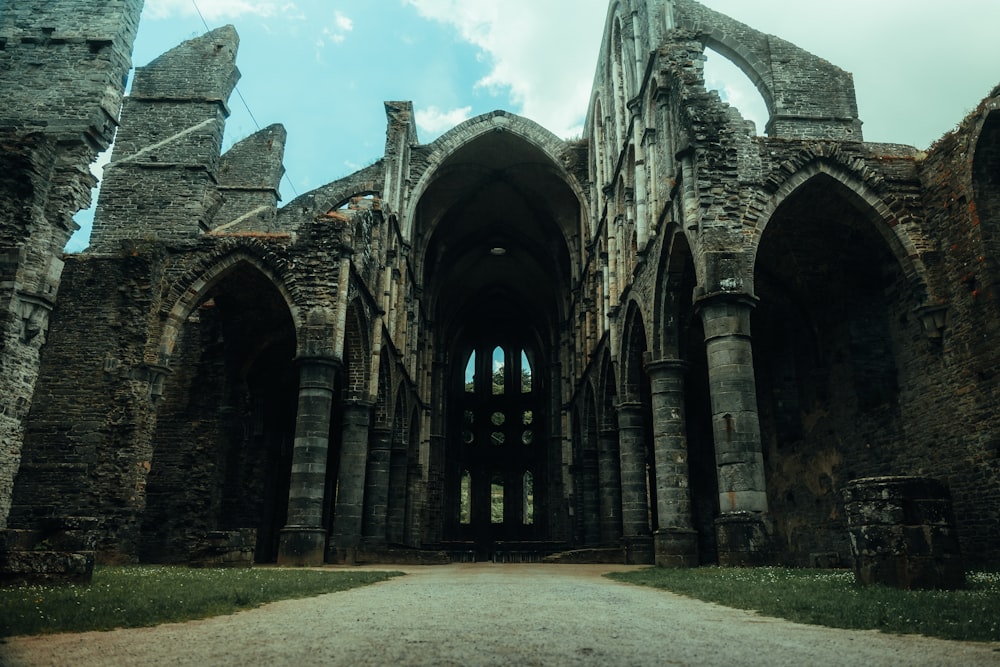 a stone building that has a bridge in the background