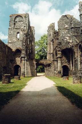 a stone castle next to a brick wall