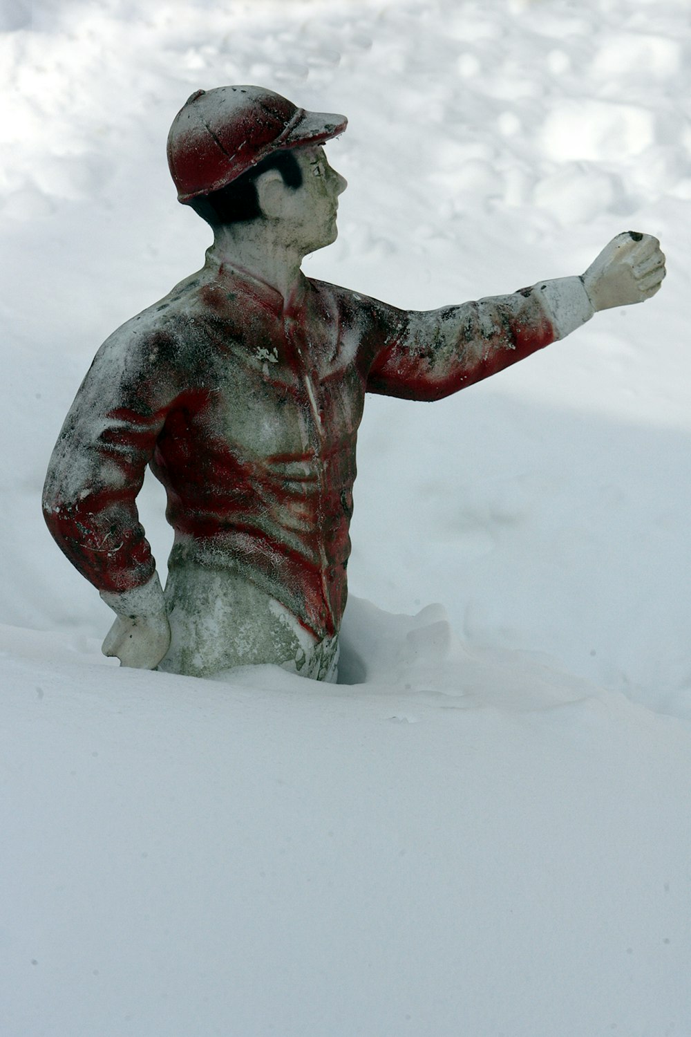 Una statua di un uomo seduto nella neve