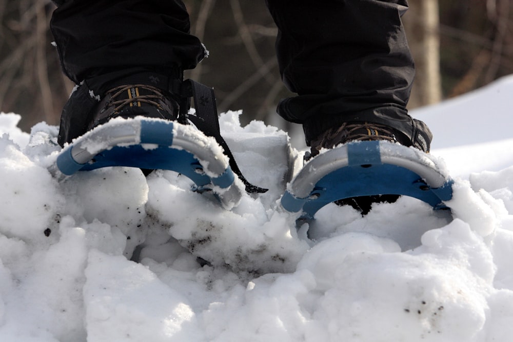 a person standing on top of a pile of snow