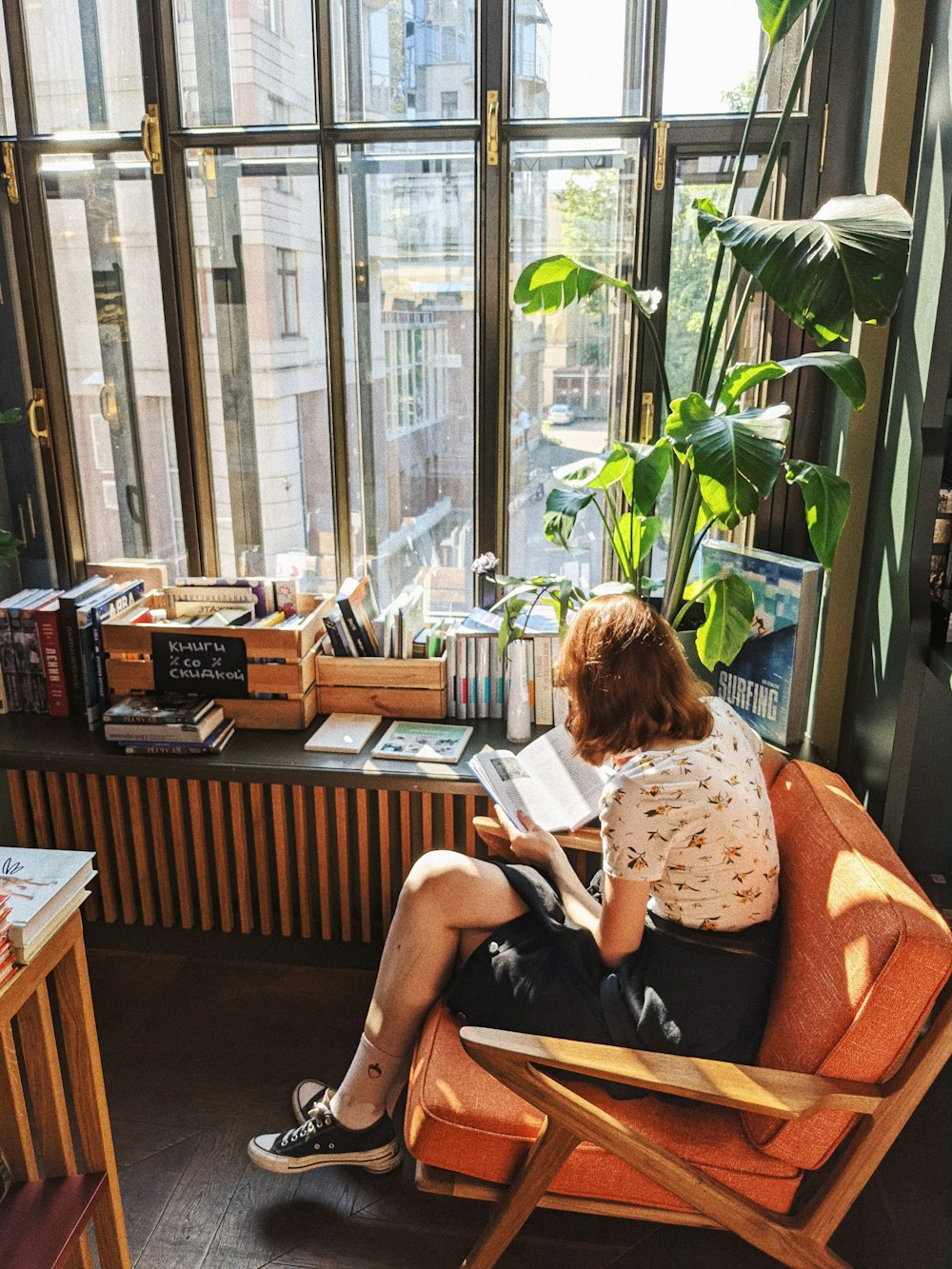 a woman sitting in a chair reading a book