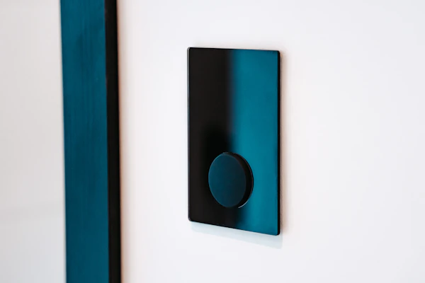 Modern electrical switches with soft white illumination on a black panel