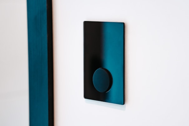 Close-up of a sleek smart light switch with ambient room lighting