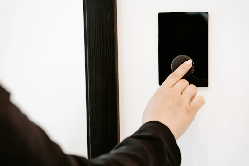 Person using a wall-mounted access control panel