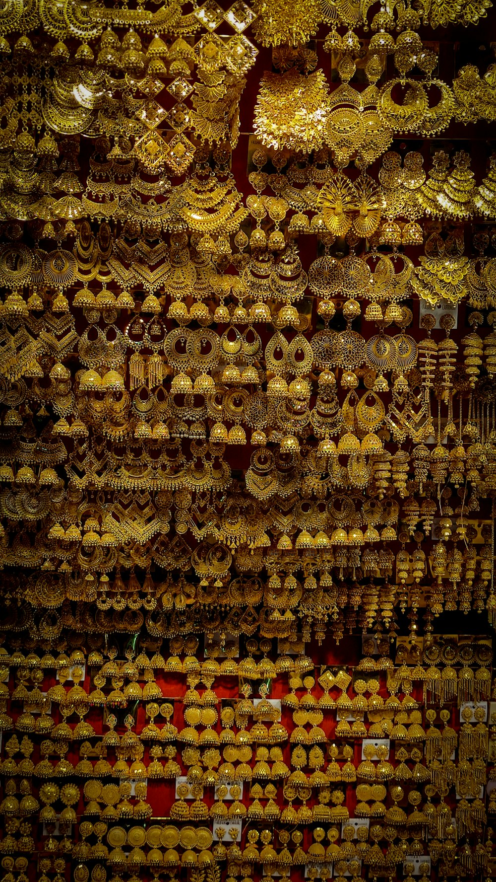 a wall covered in lots of gold jewelry