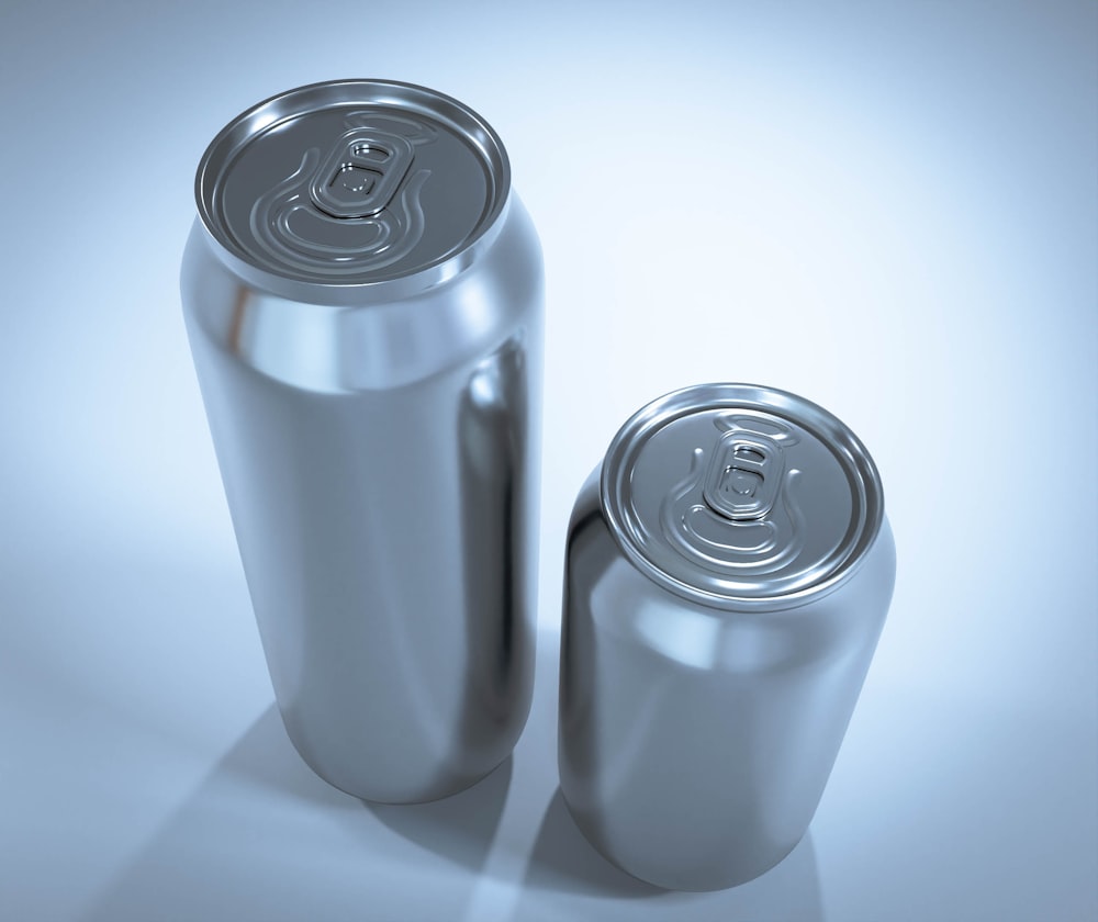 two cans of soda on a white background