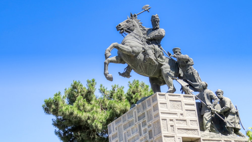 a statue of a man riding on the back of a horse