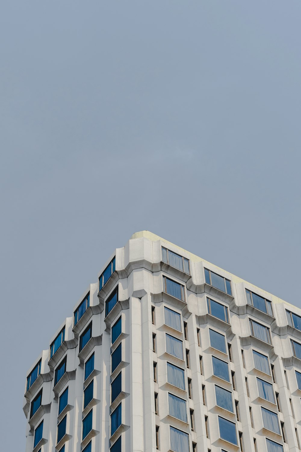 an airplane flying in the sky over a building