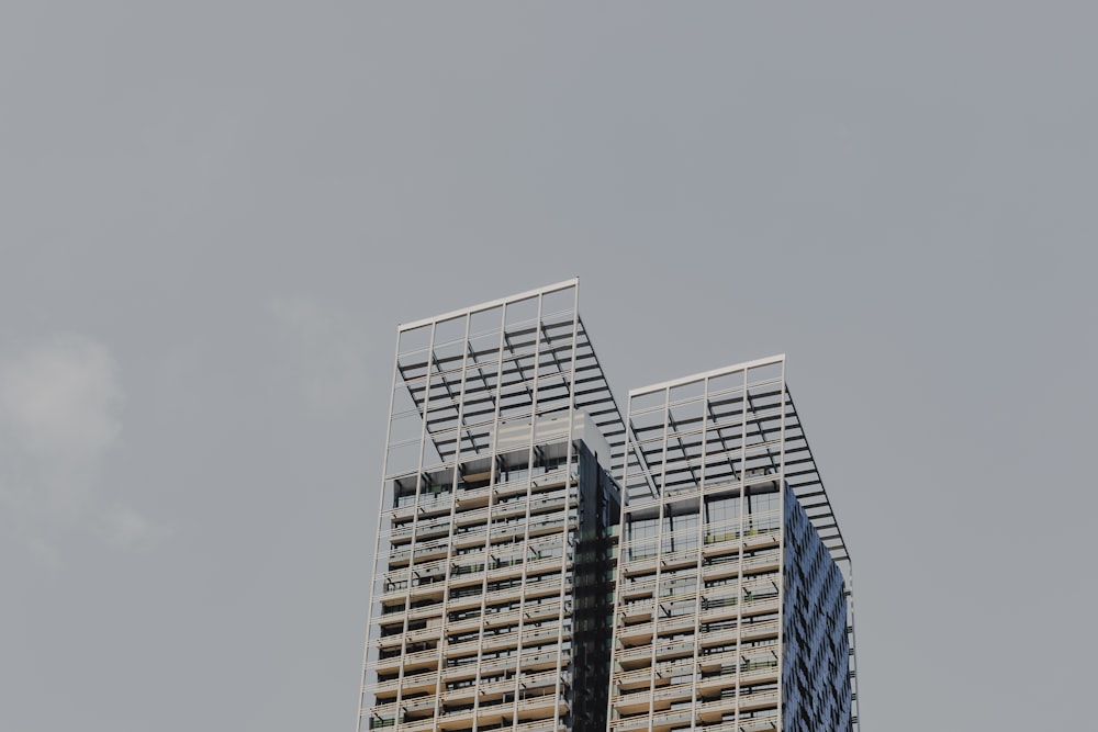 two tall buildings with a sky background