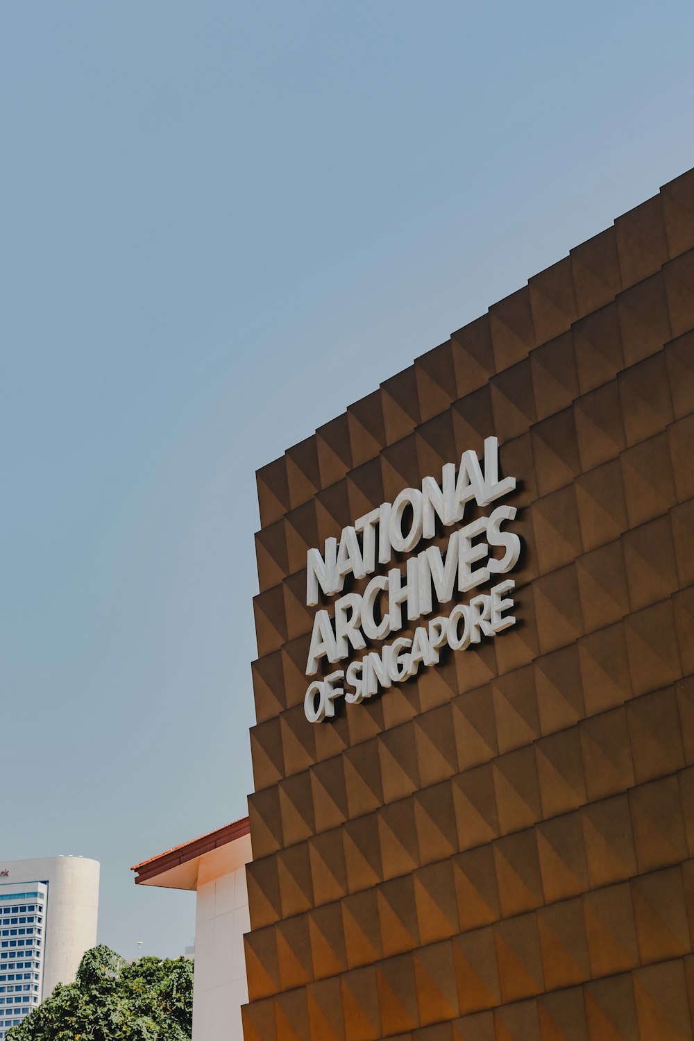 the national archives of singapore sign on the side of a building