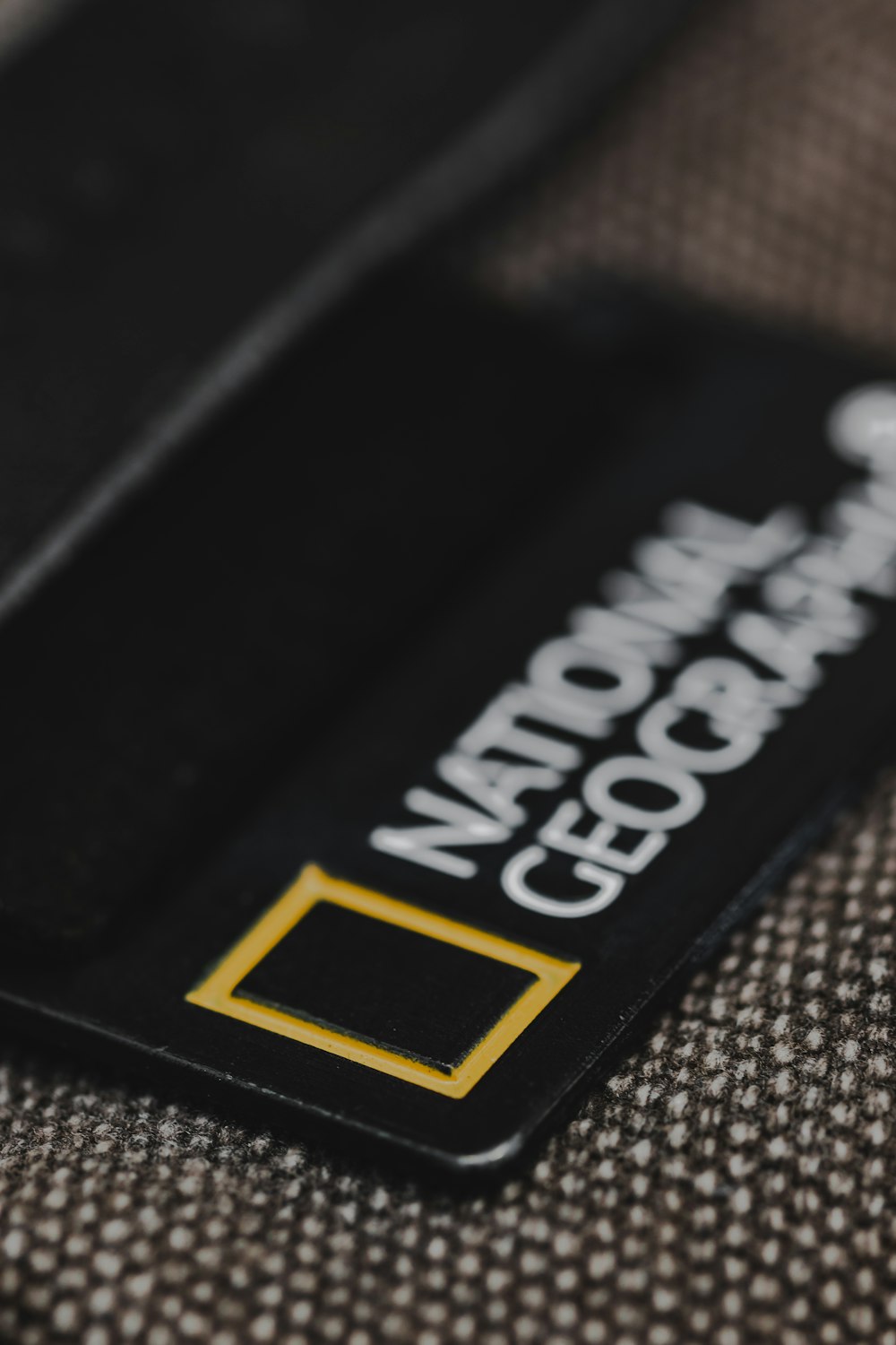 a close up of a black and yellow business card