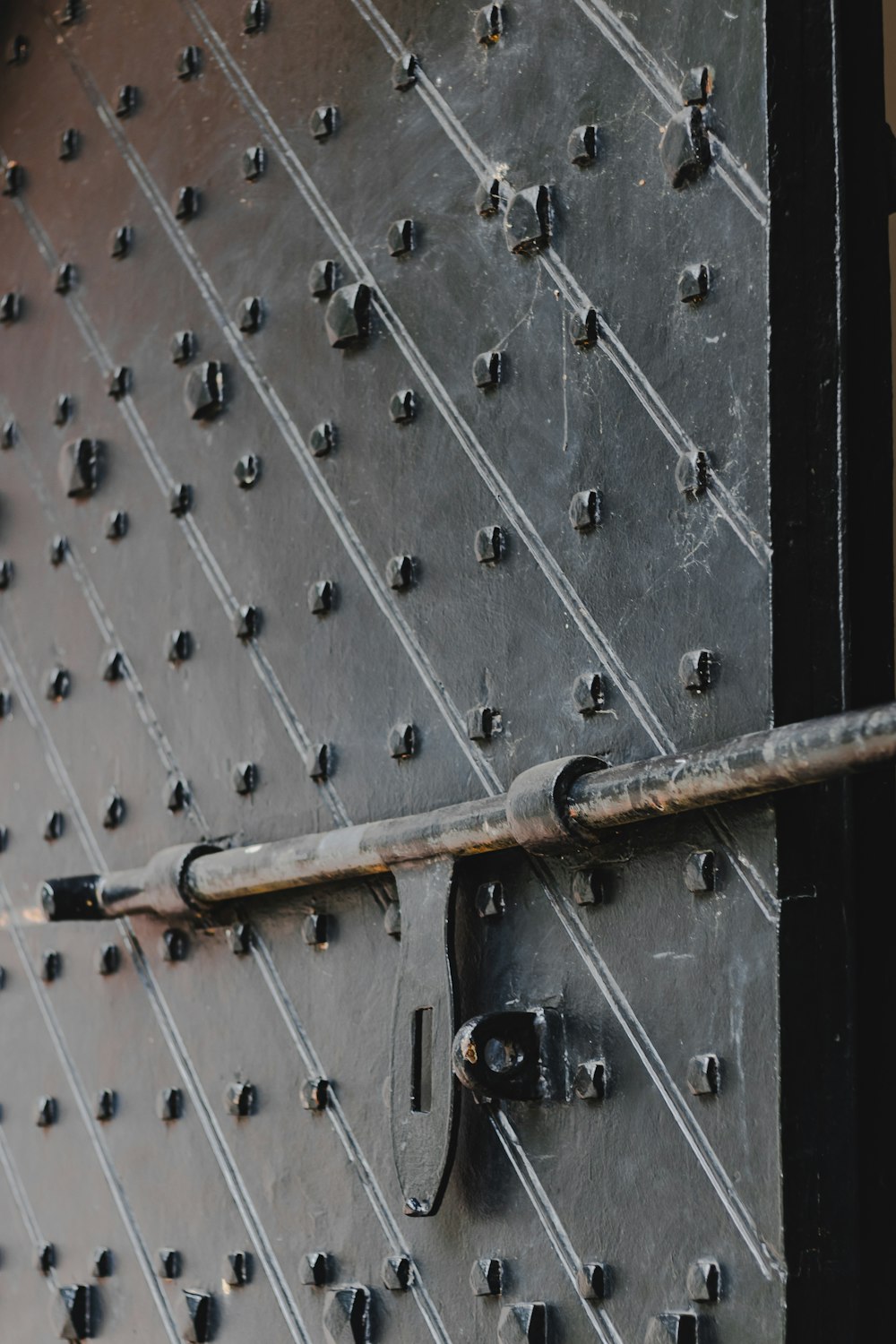 a close up of a metal door with rivets