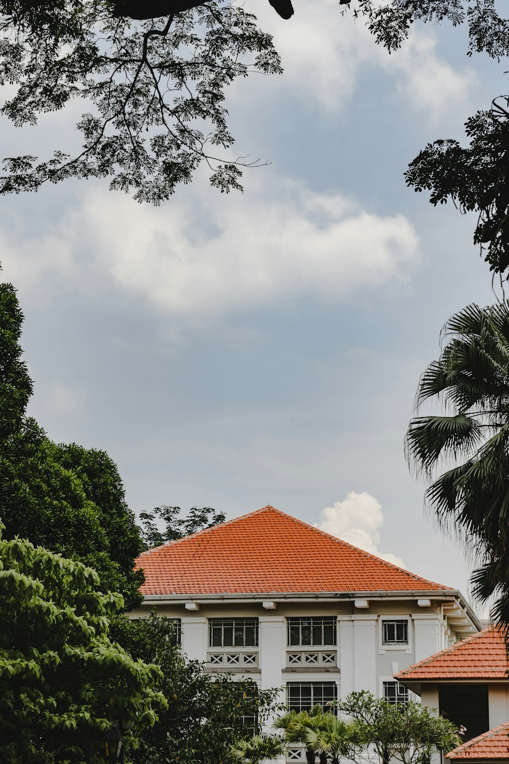 a tall white building with a red roof