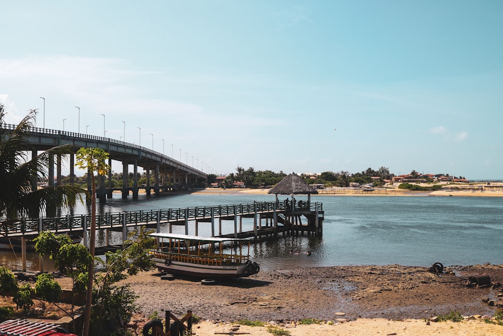 a bridge over a body of water next to a beach