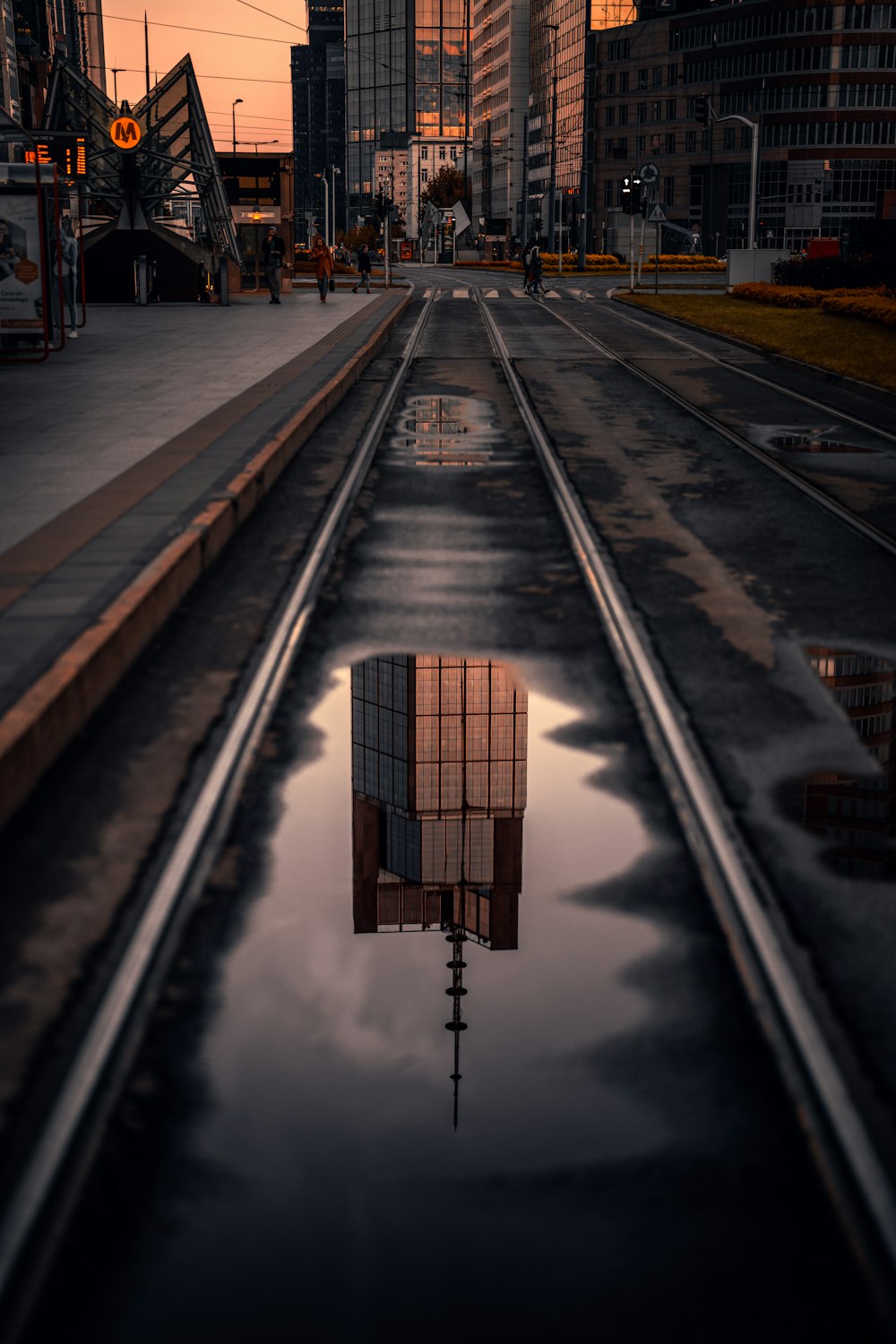 a reflection of a building in a puddle of water