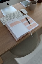 an open notebook sitting on top of a wooden desk