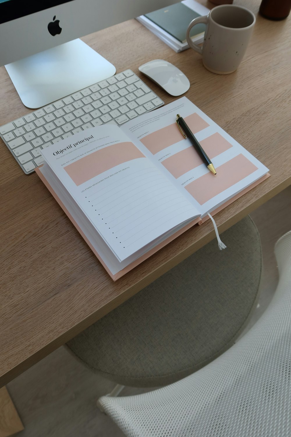 an open notebook sitting on top of a wooden desk