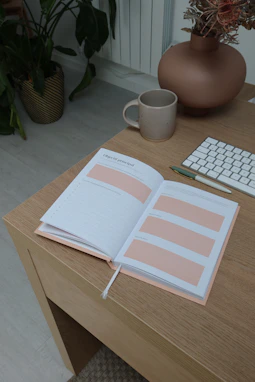 A tidy workspace featuring labeled storage bins and a clean desk with light pink accents.