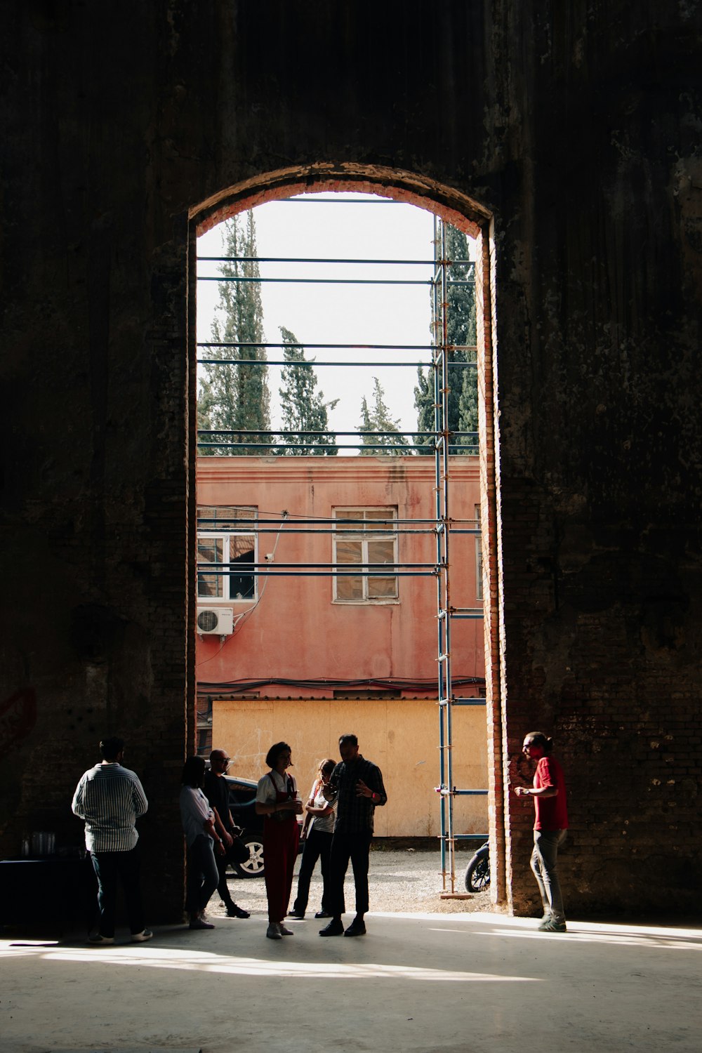 a group of people standing under a bridge