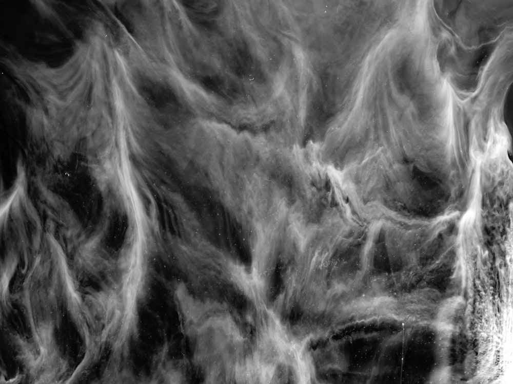 a black and white photo of some smoke