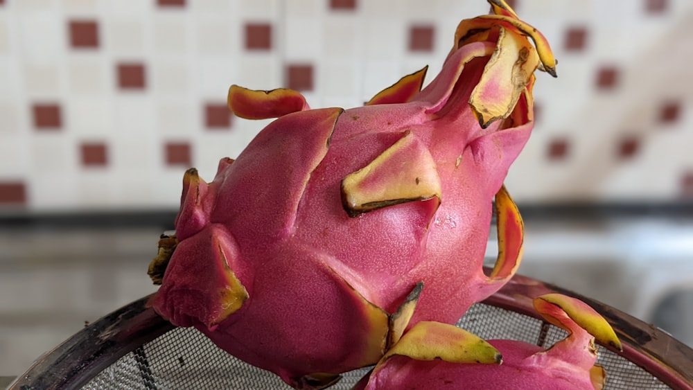 a dragon fruit sitting on top of a net