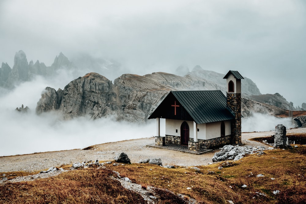 a small church with a cross on top of it