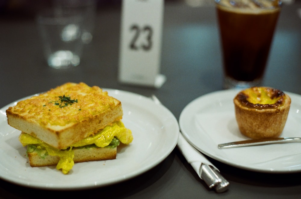 due piatti con panini e un muffin su un tavolo