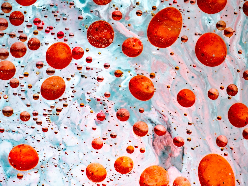 a mixture of red and white bubbles floating in water