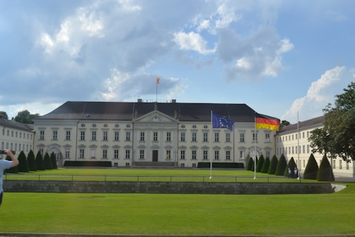 An outdoor shot of the Deutsche Research foundation building with researchers entering, symbolizing collaboration.