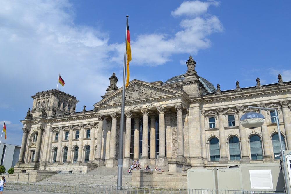 a large building with a flag pole in front of it